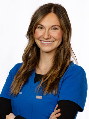 Professional dental staff member in blue scrubs smiling at Fremont Dental Group office
