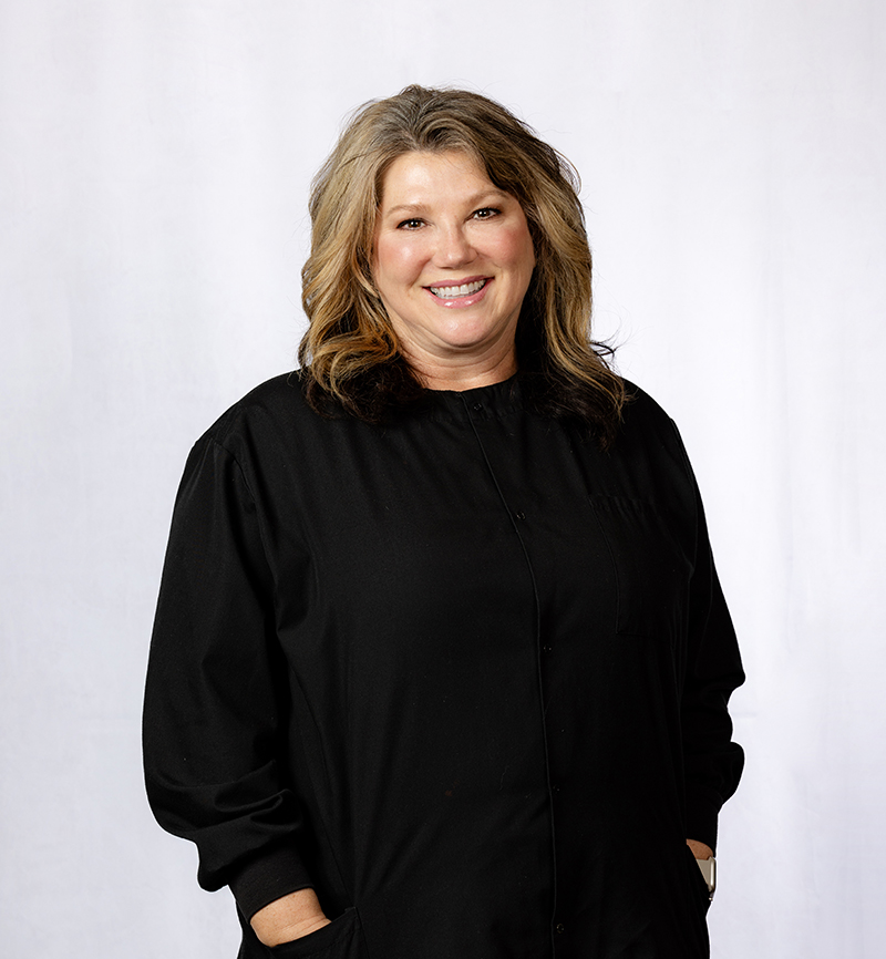 Professional headshot of a woman with shoulder-length blonde hair wearing black against white background.